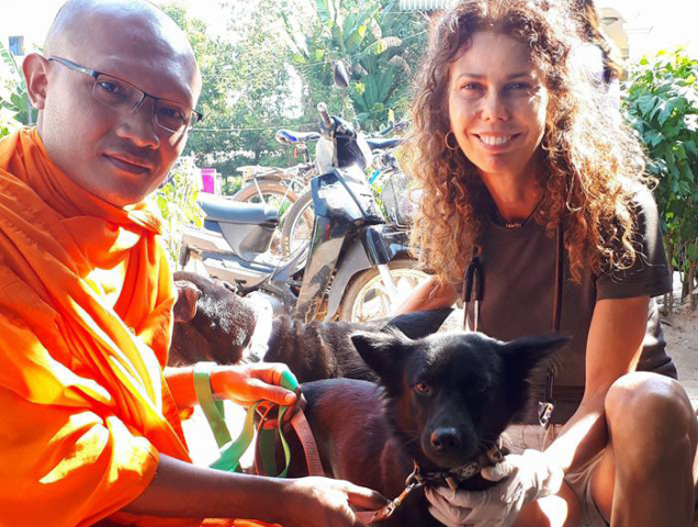 rspca vet smiling with monk and dog